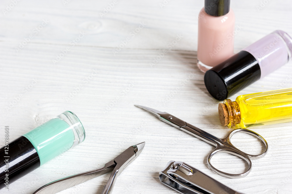 nail polish and manicure set on wooden background