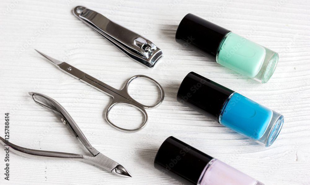 nail polish and manicure set on wooden background