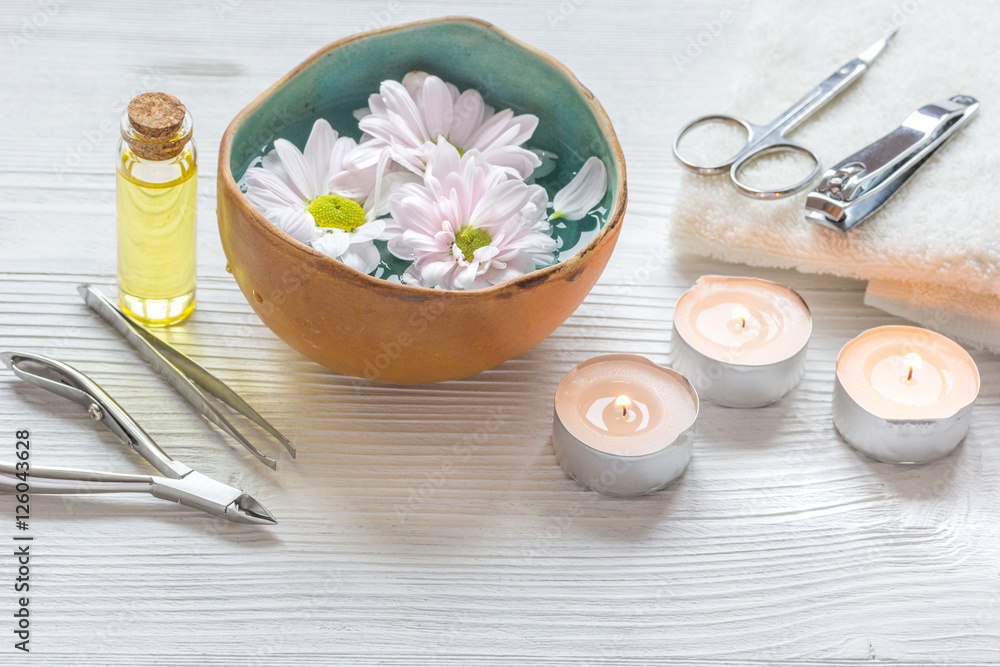 spa nail care with tea candle on wooden background