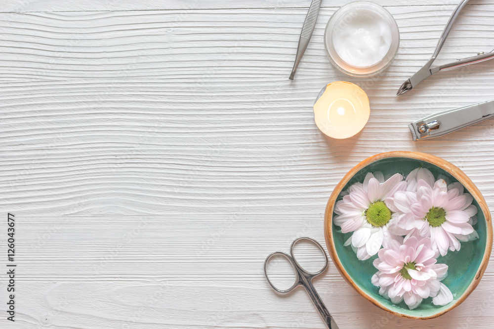 spa nail care with tea candle wooden background top view