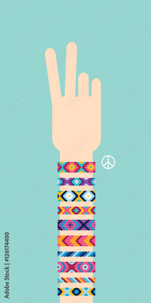 Hand with hippy friendship bracelets making victory sign