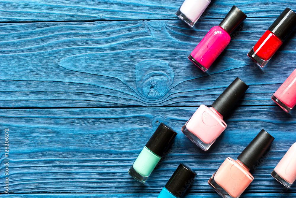 lot of bottles nail polish on wooden background top view