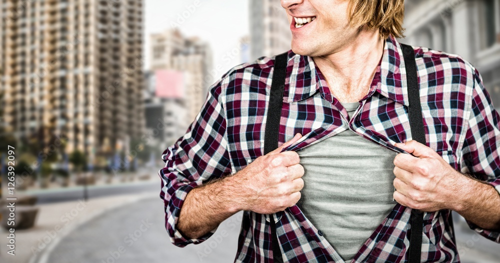 Composite image of funny blond hipster taking off his shirt