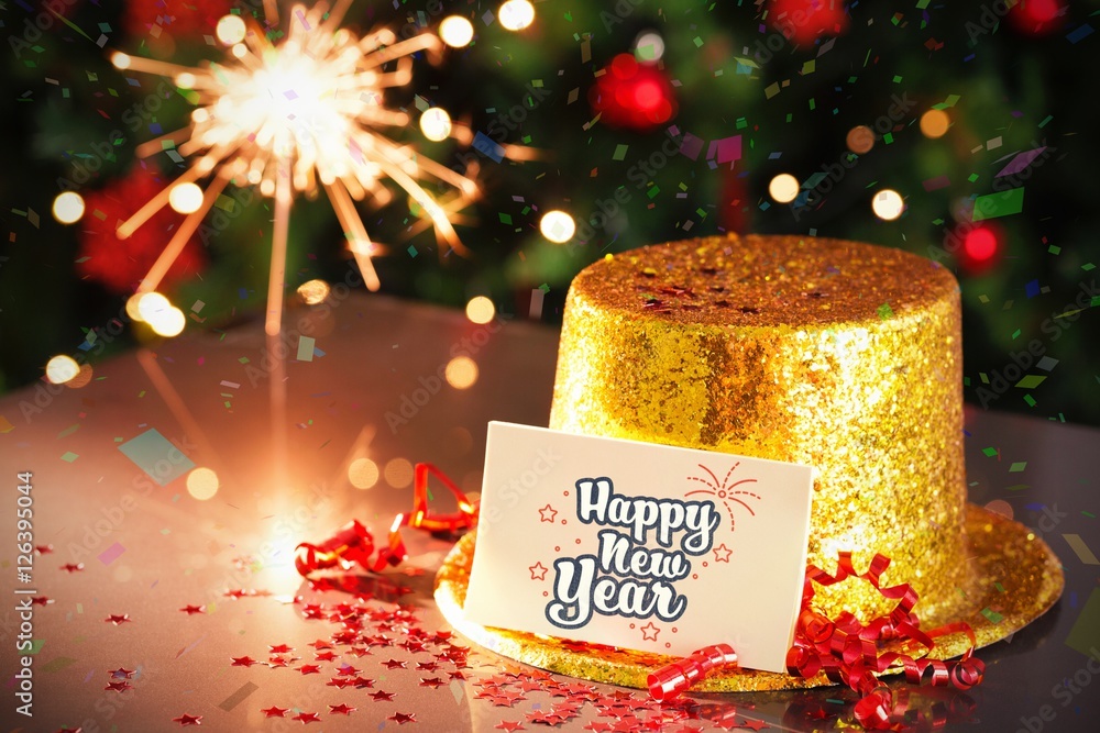  Digital composite of Happy new year card leaning on gold party hat