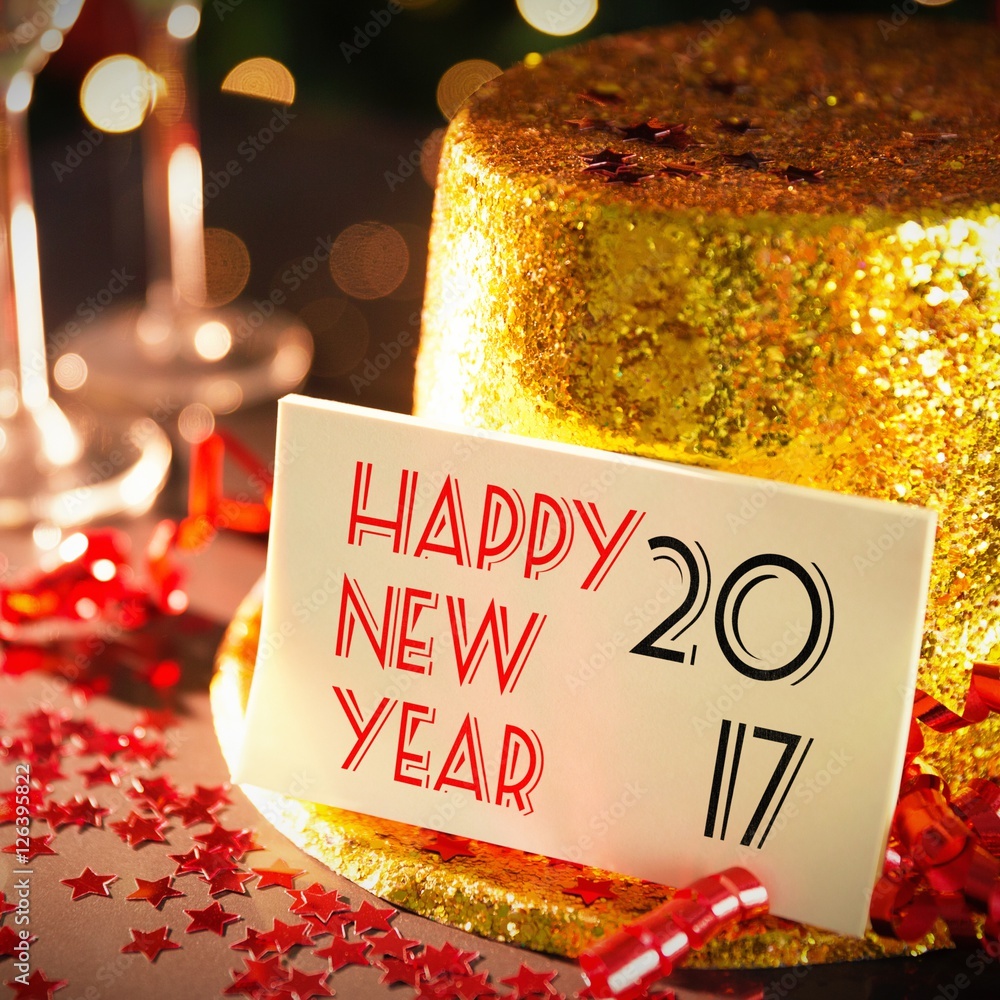  Digital composite of Happy new year card leaning on gold party hat