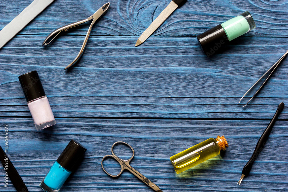 nail polish and manicure set on dark wooden background