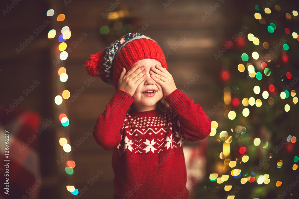 little girl  in anticipation of a Christmas miracle and a gift