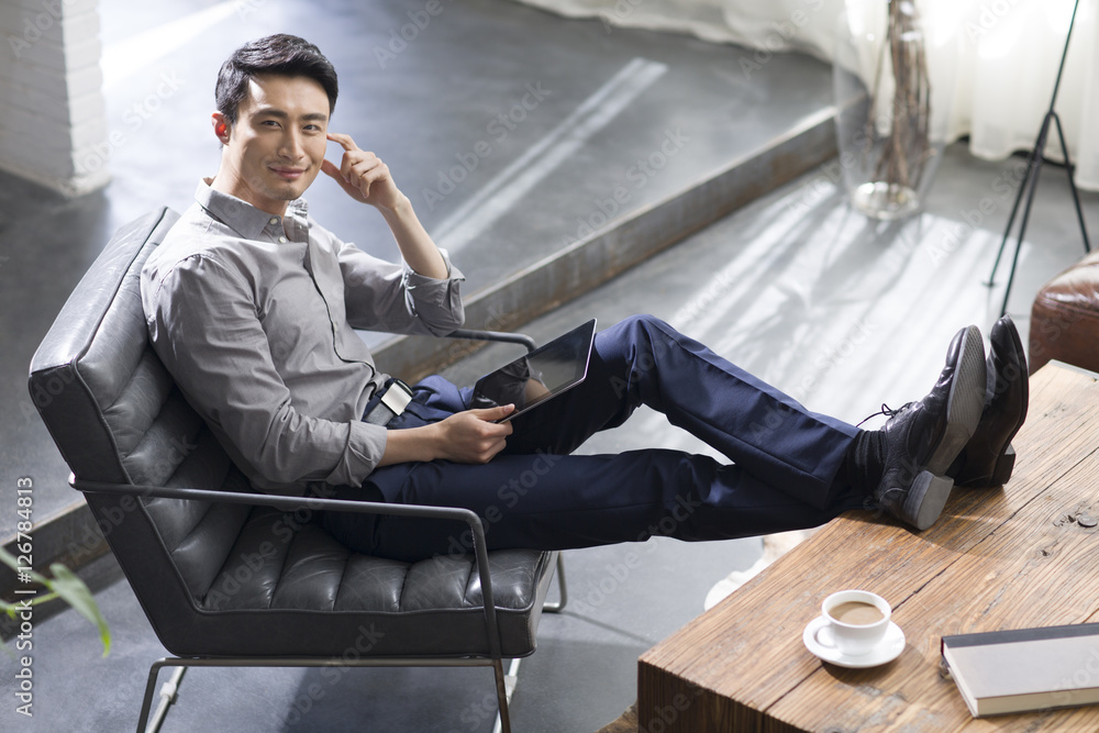 Young man using digital tablet in office