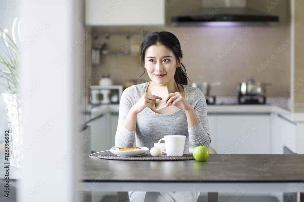 年轻女人在家吃早餐