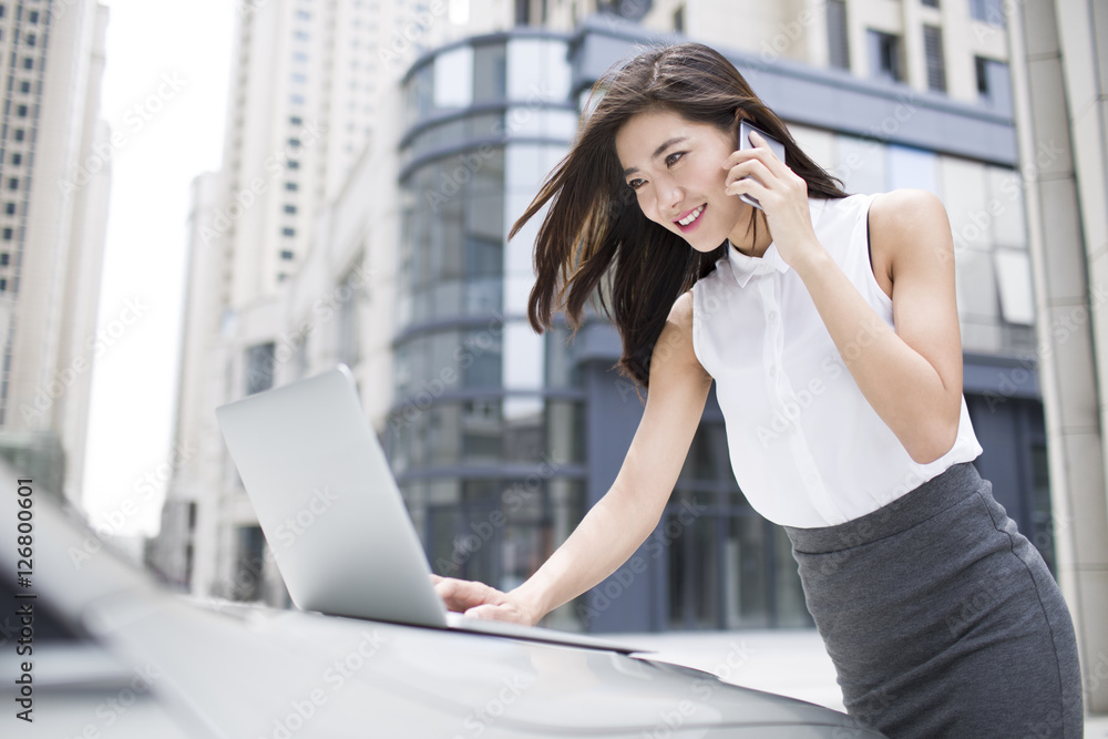 Confident businesswoman talking on cell phone