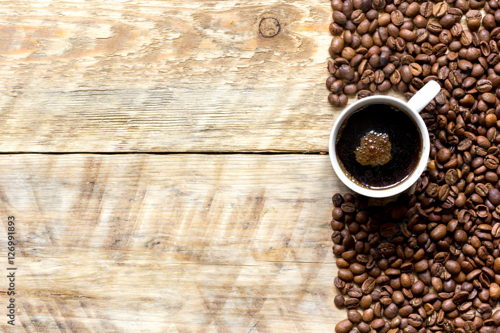 coffee beans on wooden with coffe cup table top view