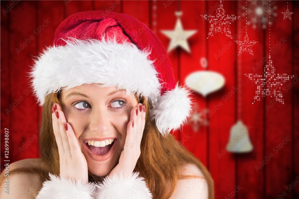 Surprised woman in santa costume against digitally generated bac