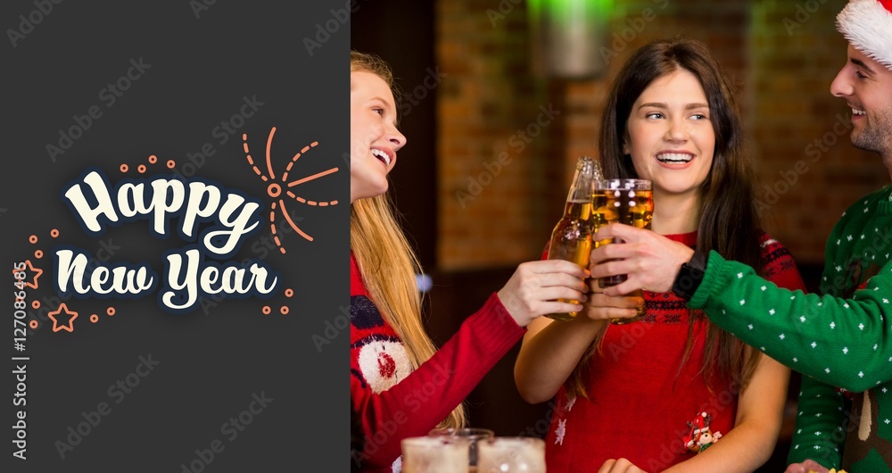 Composite image of cheerful friends having drinks during christm