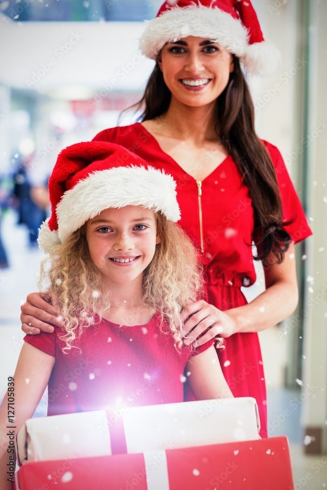 Composite image of portrait of mother and daughter in christmas 