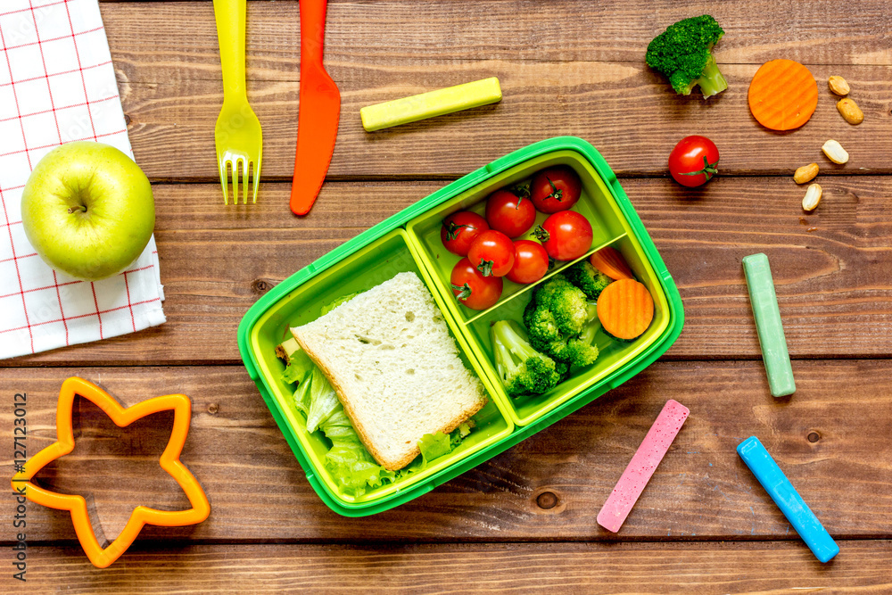 ingredients for childrens lunch on wooden background top view