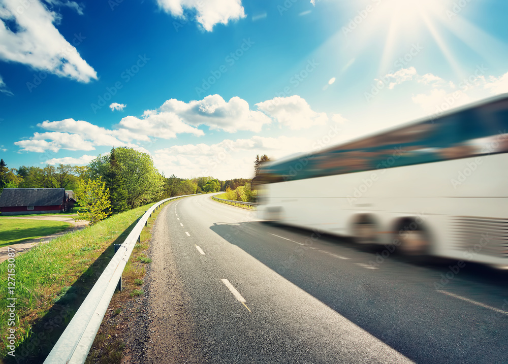 Bus on asphalt road in beautiful spring day at countryside