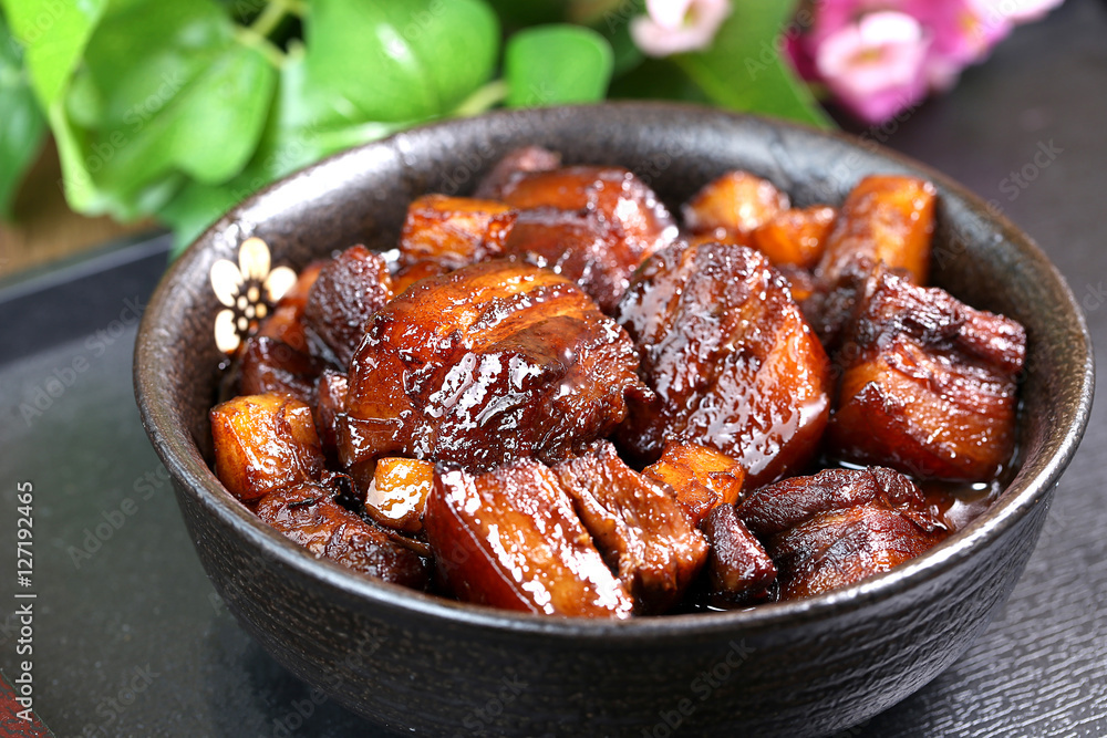 A large bowl of Braised pork in brown sauce