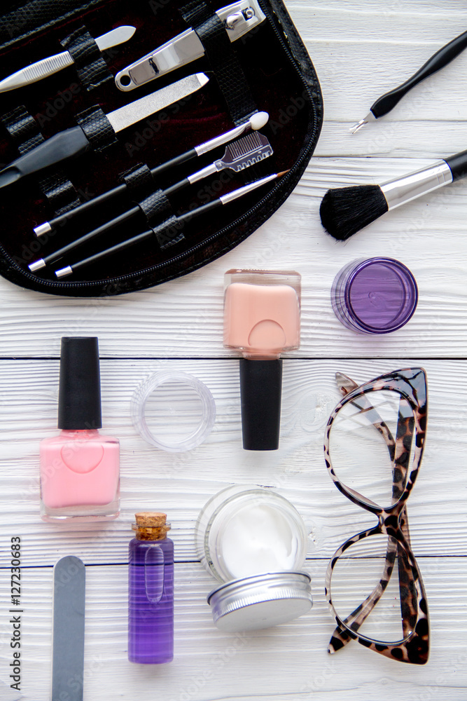 manicure set and nail polish on wooden background