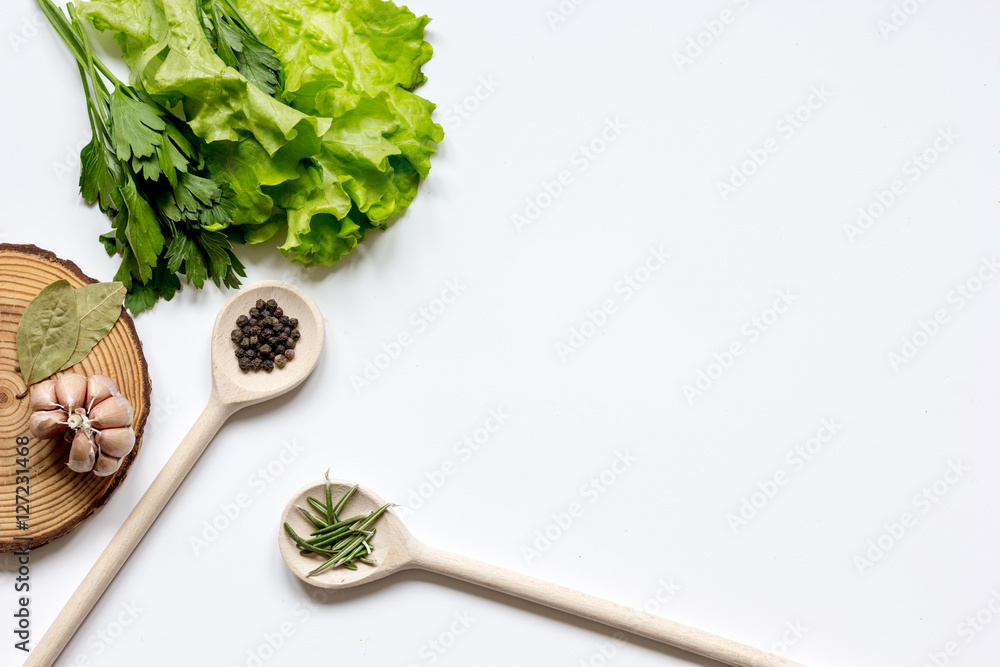 various spices in spoon with wooden stand on white background