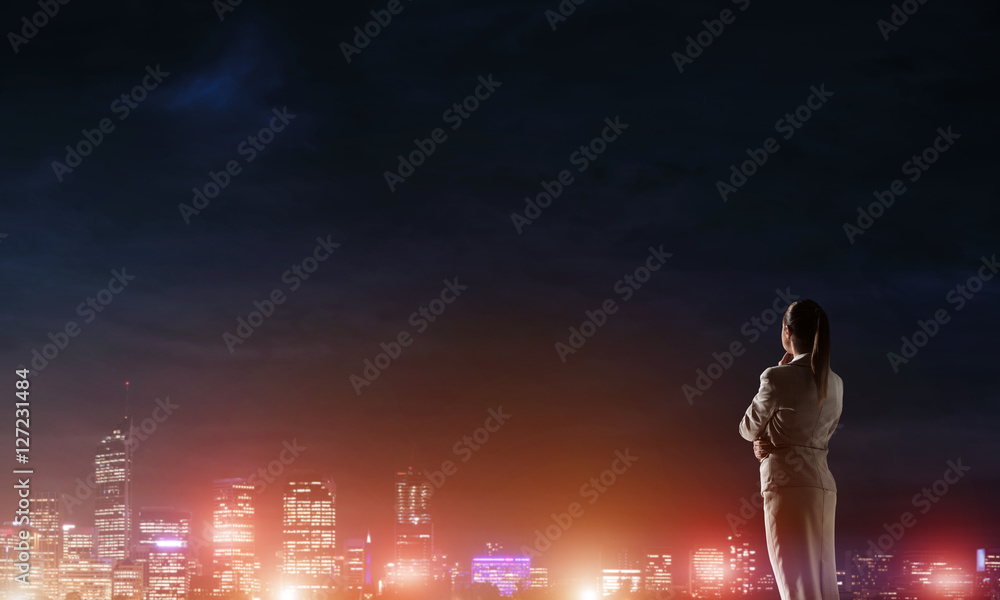 Woman looking at night city