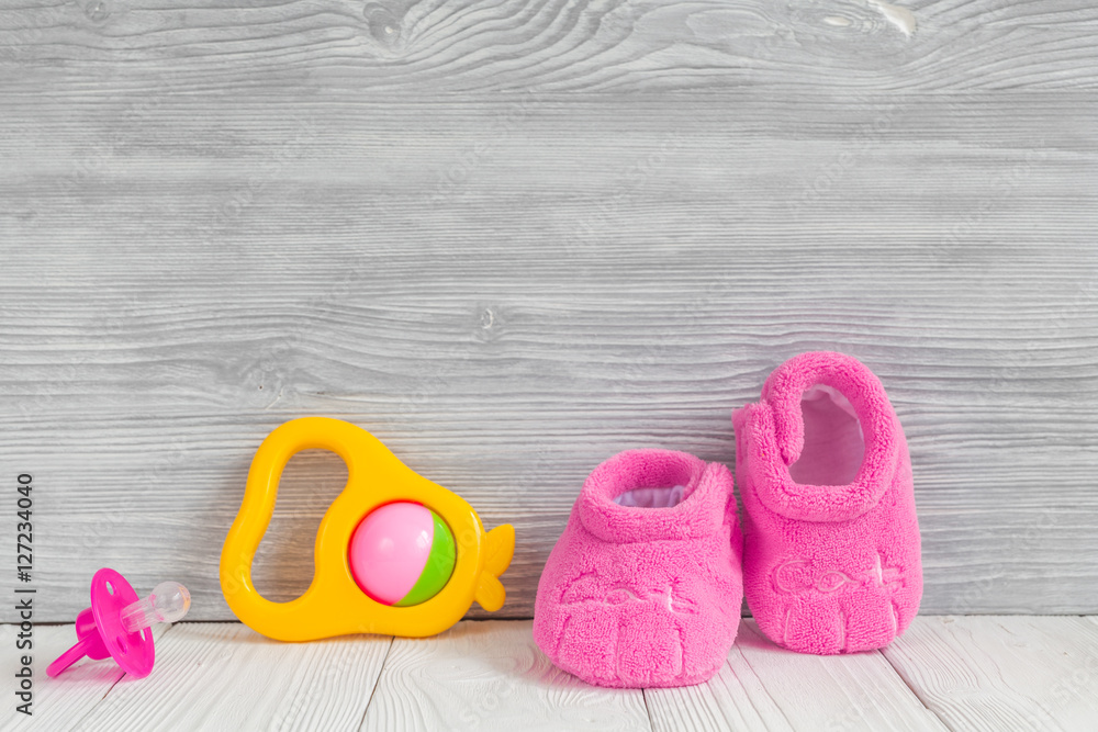 pink booties on wooden background