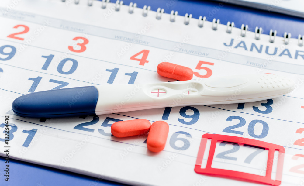 Positive pregnancy test with calendar top view