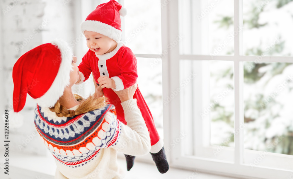  happy family mother and baby playing at home  white window for Christmas