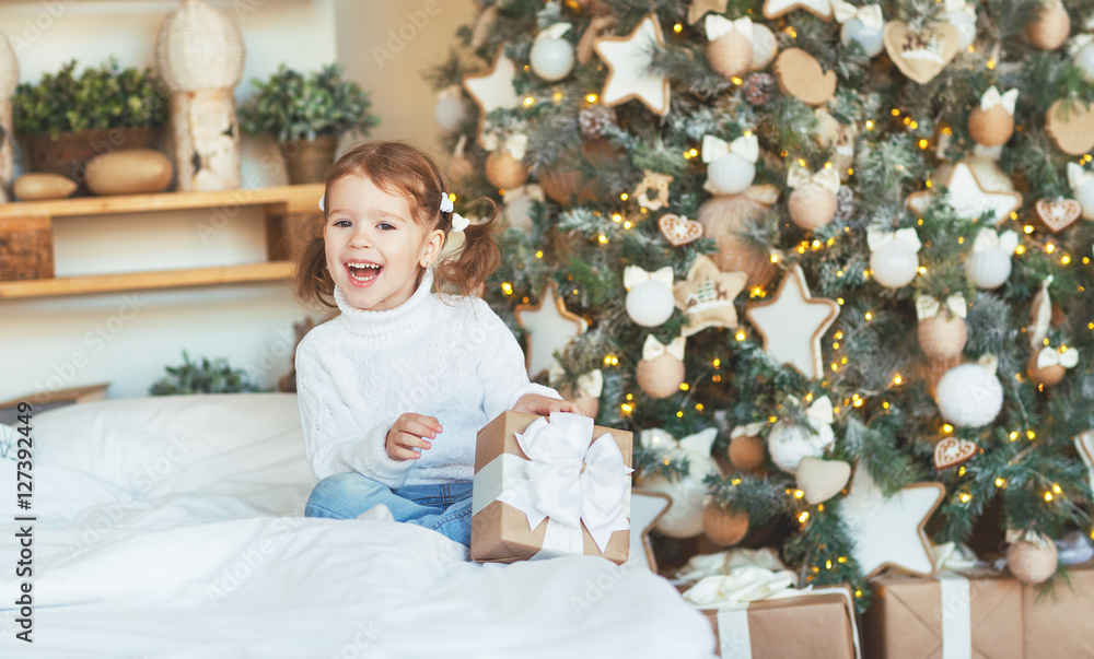 happy child girl with Christmas present morning