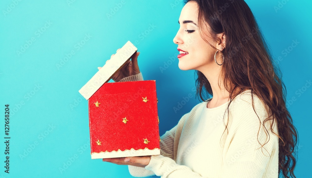 Happy young woman with Christmas present box