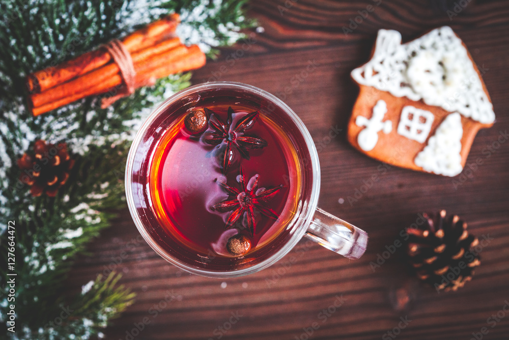 cup with christmas mulled wine on wooden background top view