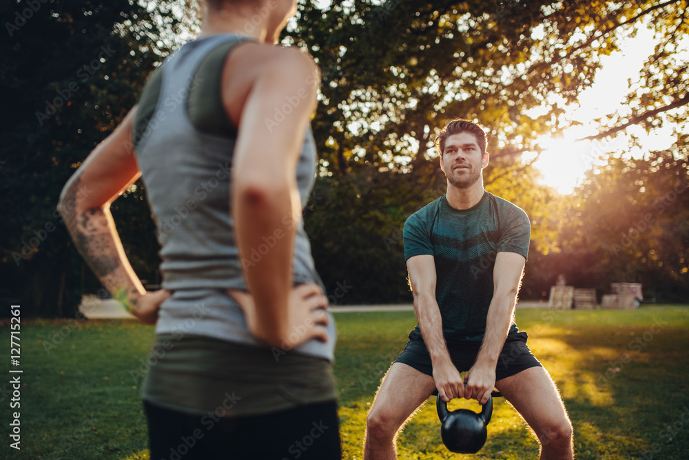 Fitness man exercising with personal trainer