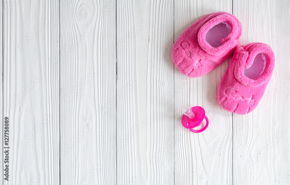 pink booties on wooden background