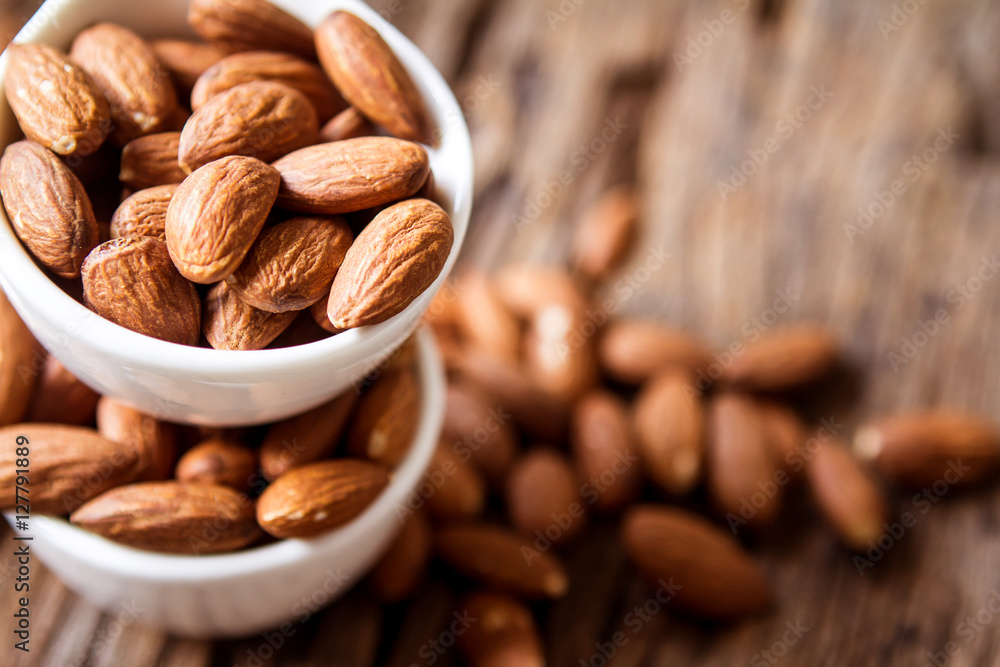 close up Peeled almonds nut  in small white cup