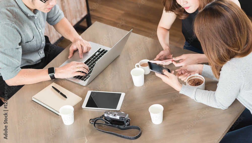 Group of friends meeting in a coffee shop chatting to each other