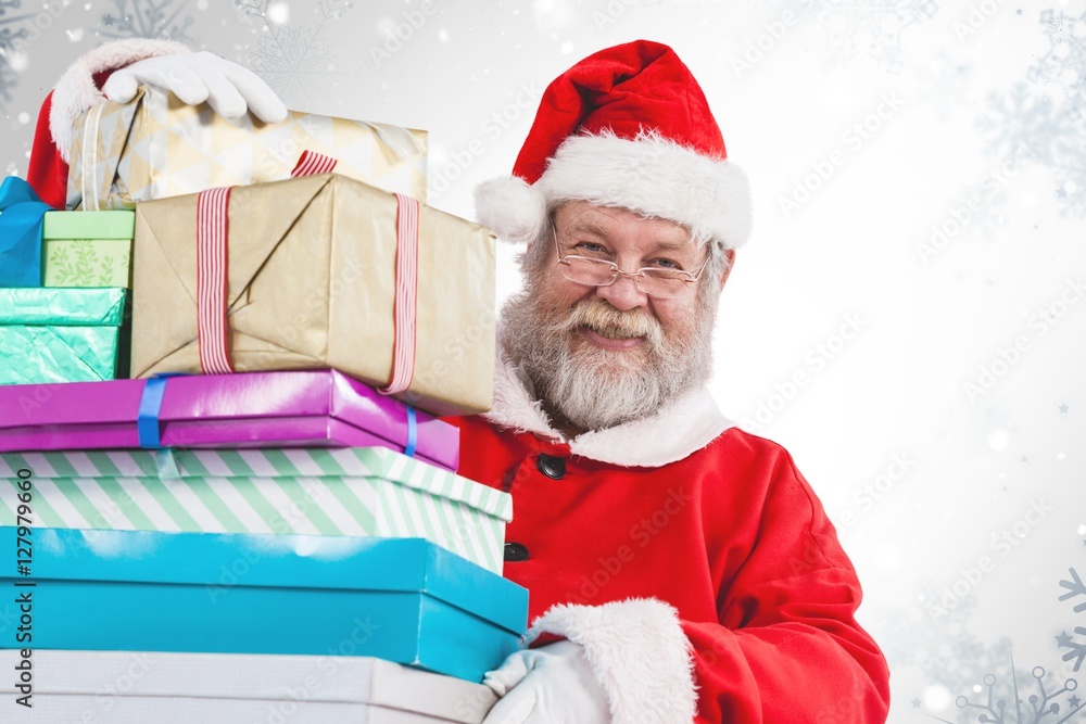 Composite image of portrait of santa claus holding christmas pre