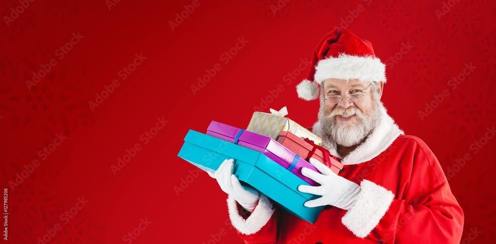 Composite image of close-up portrait of santa claus holding chri