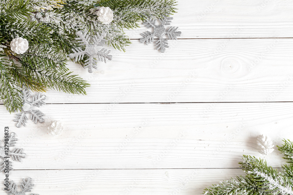 Christmas toys and spruce branches on wooden background top view