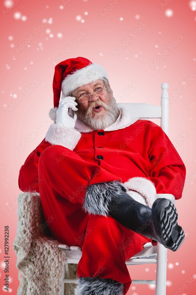 Composite image of excited santa claus talking on mobile phone