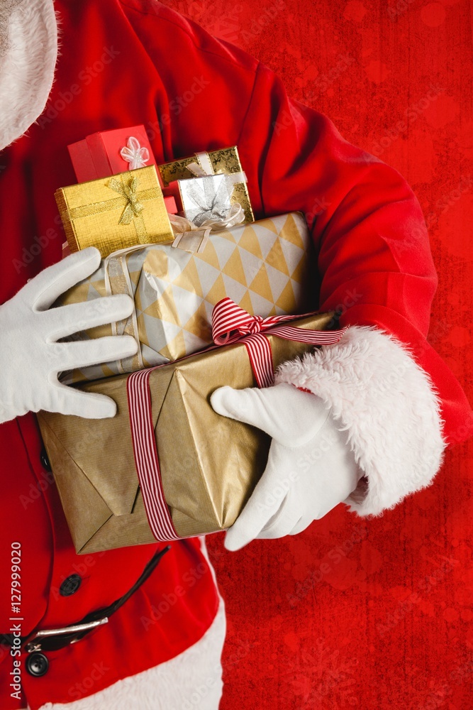 Composite image of santa claus holding presents