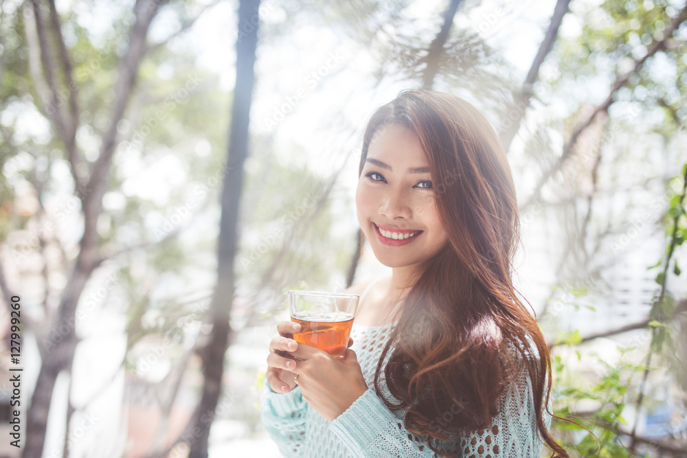 Portrait of a young asian woman drinking her morning tea. Fell r