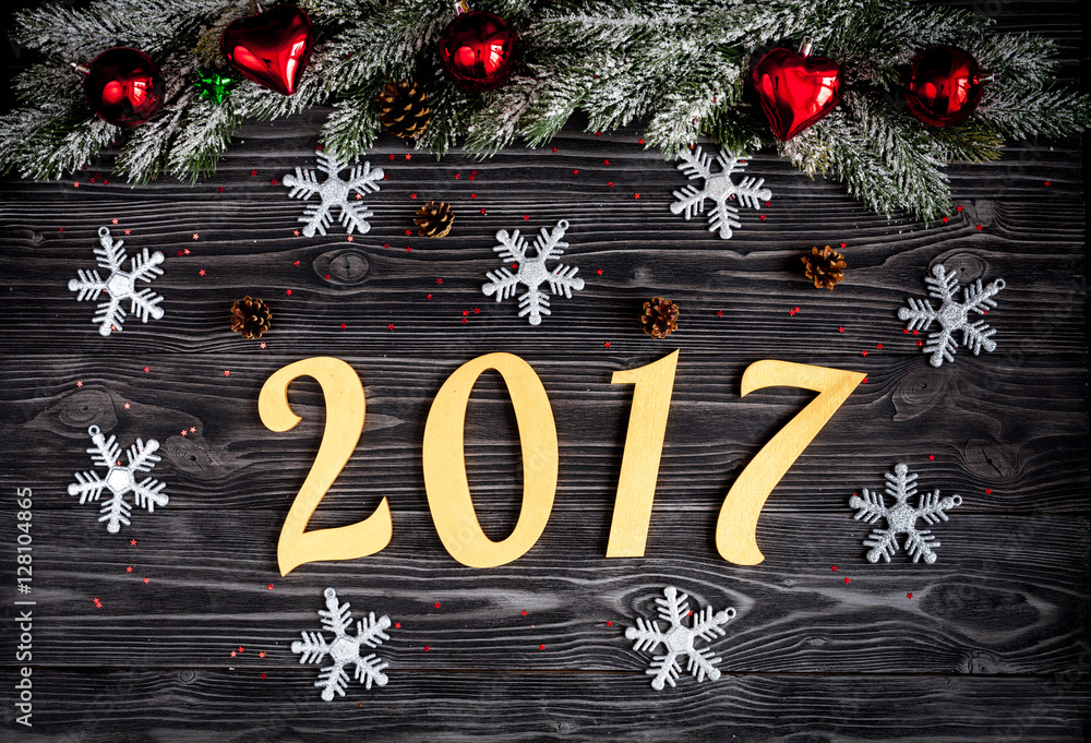 Christmas decorations, spruce branches on dark wooden background top view