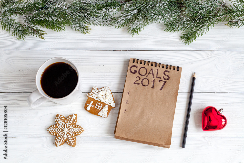 notebook and goals for new year wooden background top view