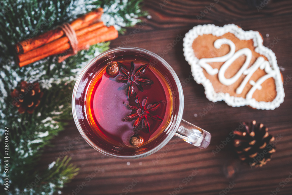 cup with christmas mulled wine on wooden background top view