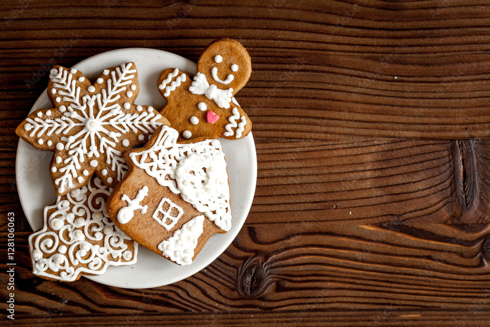 Christmas gingerbread on dark wooden background top view