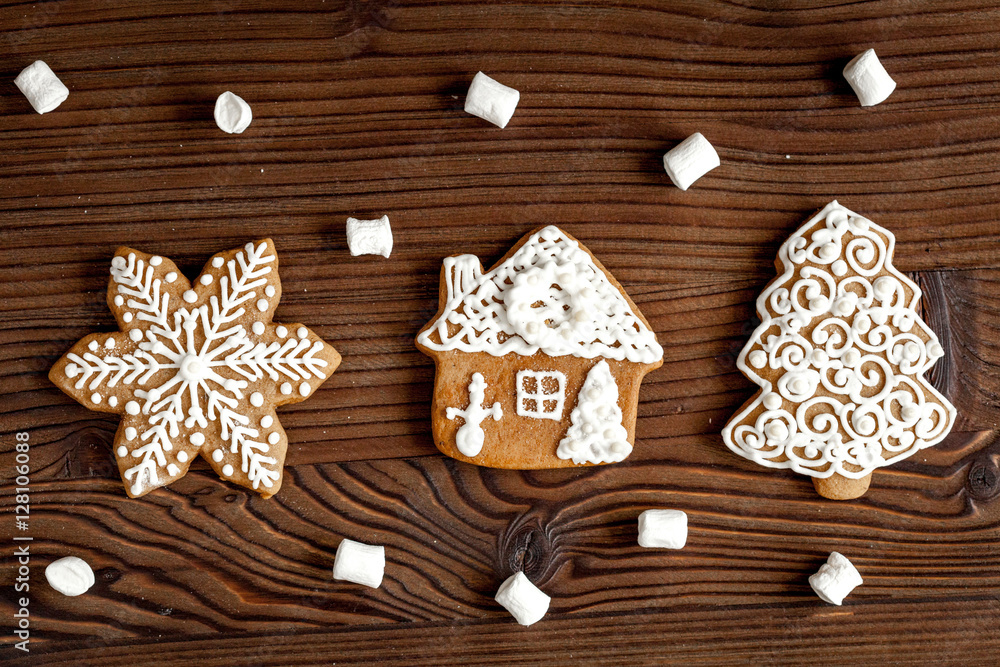 Christmas gingerbread on dark wooden background top view