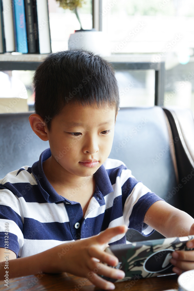 asian nauty boy holds tablet