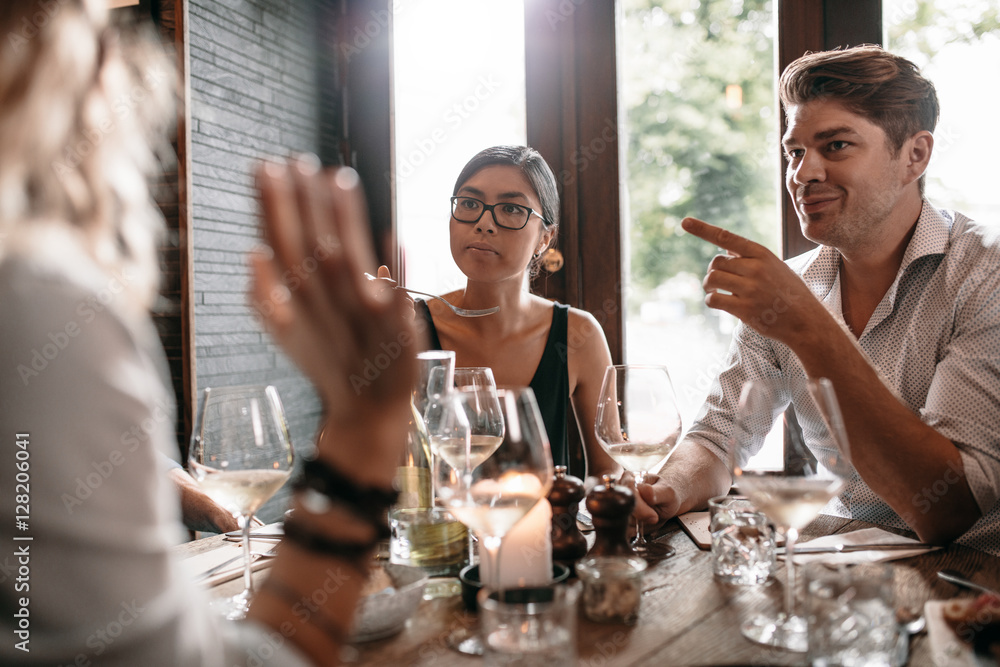 Group of friends meeting at restaurant for dinner