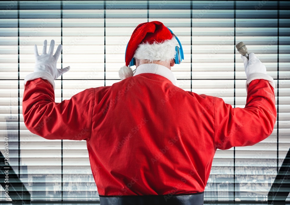 Santa listening to headphones against window