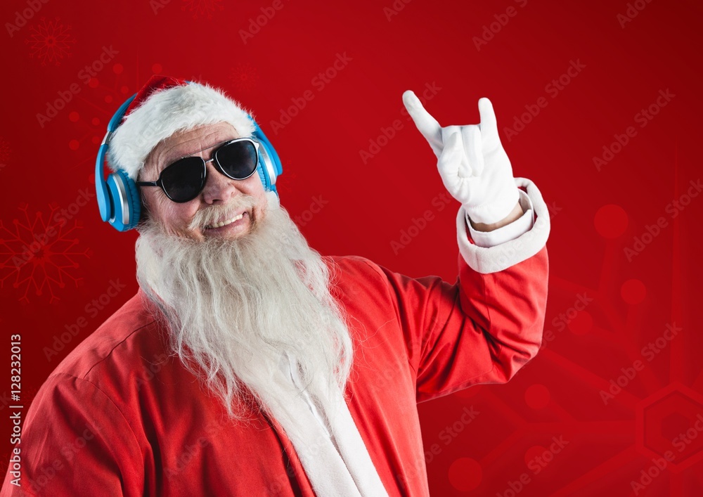 Santa claus listening music on headphones and gesturing