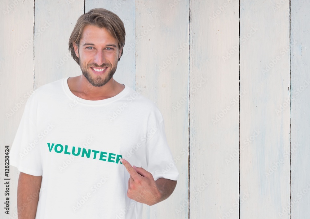 Smiling man pointing at message printed on their tshirt